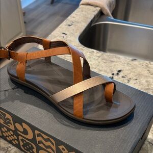 OluKai Women's Strappy Sandal in Brown and Metallic